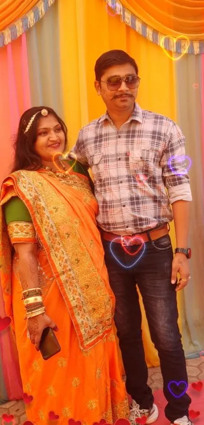 Couple in traditional attire with colorful background and heart overlay.