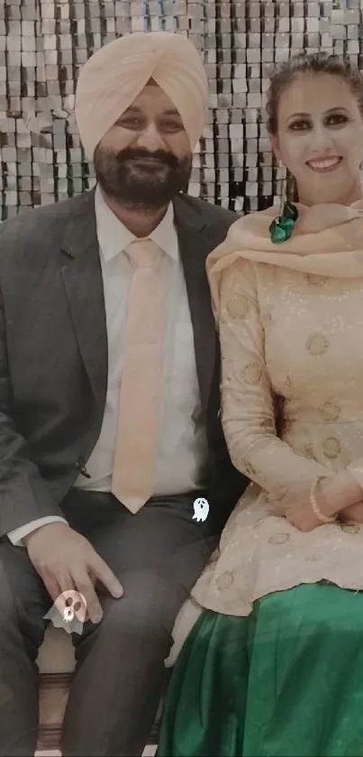 A couple in elegant traditional attire seated together, exuding cultural charm.