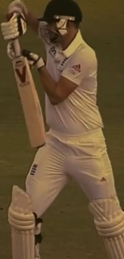 Cricketer in white gear poised for action on the field.