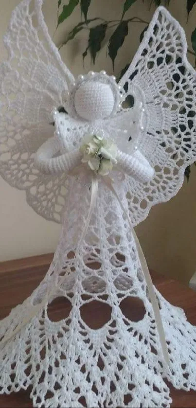 Elegant crochet angel with intricate lacework on display table.