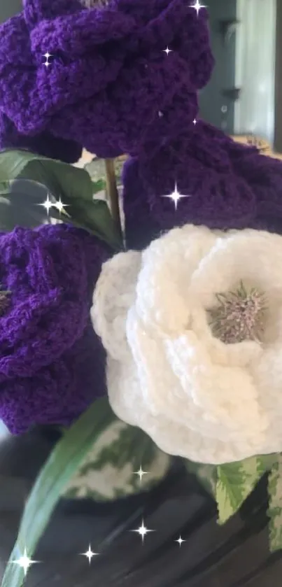 Purple and white crocheted flowers with leaves.