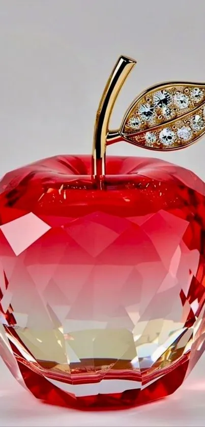Crystal apple with jeweled leaf on display.