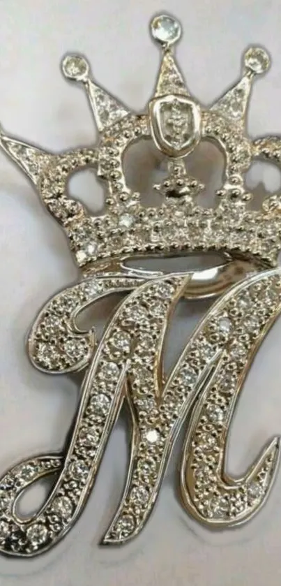 Silver jeweled crown and initial M design wallpaper.