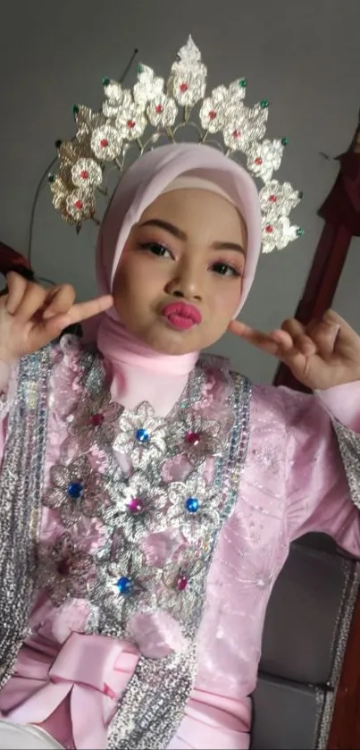 Woman in a pink traditional dress with intricate headpiece.