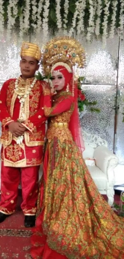 Couple in traditional wedding attire with red and gold accents.