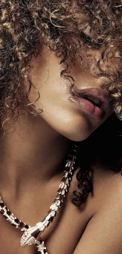 Elegant woman with curly hair and necklace in artistic pose.