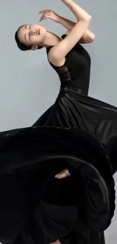 Elegant dancer in black dress with graceful pose.