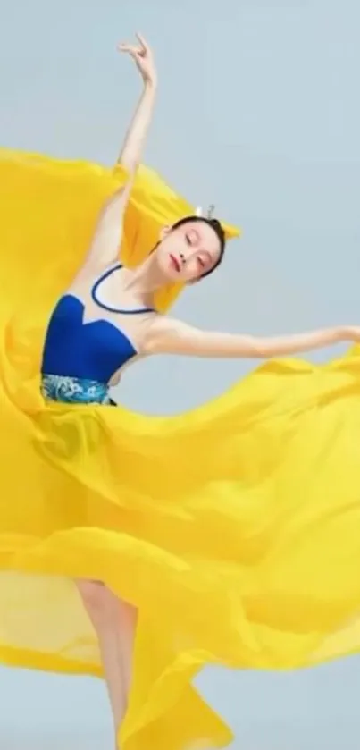 Dancer in a graceful pose with a flowing yellow dress.