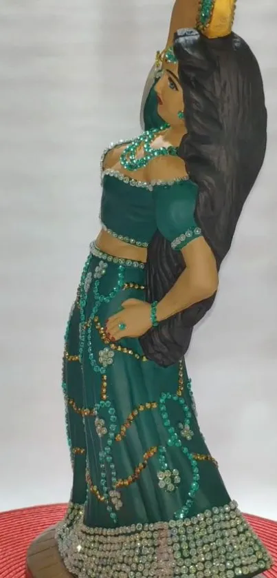 Elegant teal statue in graceful dance pose with intricate beadwork.