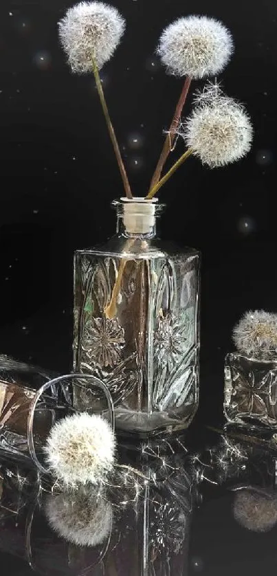 Elegant crystal vases with dandelions on reflective black surface.