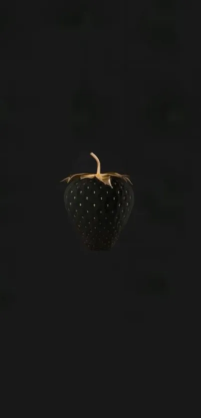 Sleek black strawberry with gold highlights on dark wallpaper.