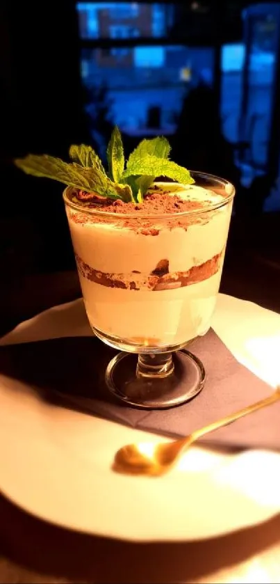 Elegant tiramisu dessert on a table with mint leaves.