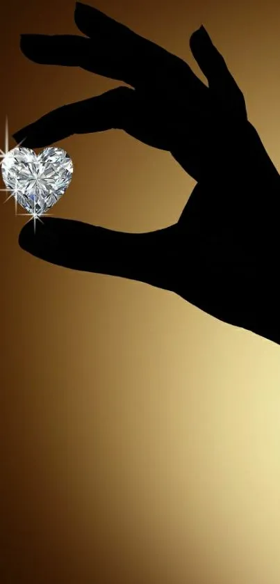 Silhouette hand holding a sparkling diamond heart on a golden background.