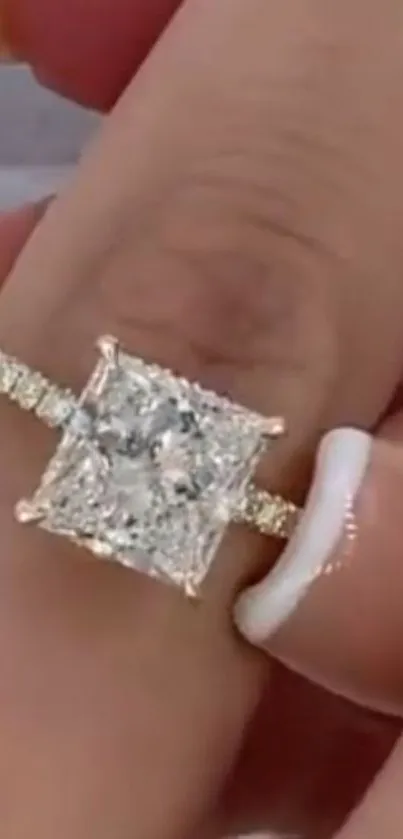 Close-up of a luxurious diamond ring on a finger.