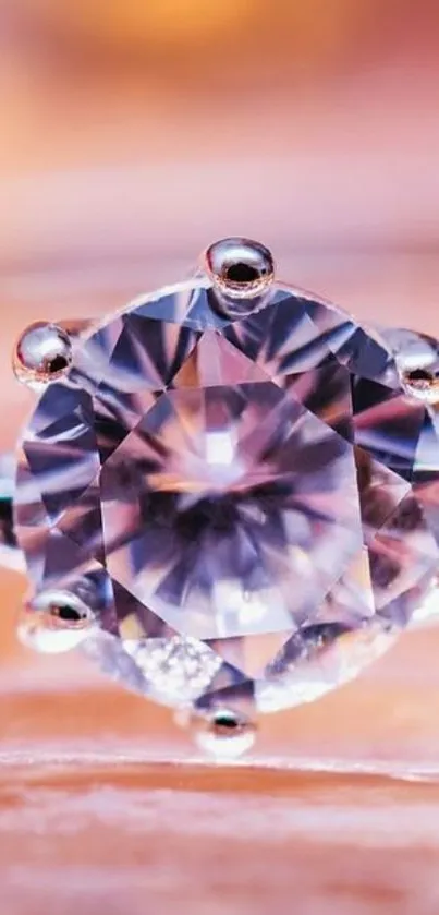 Close-up of a sparkling diamond ring with a peach-colored background.