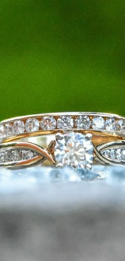 Close-up of a diamond ring with a gold band on a green background.