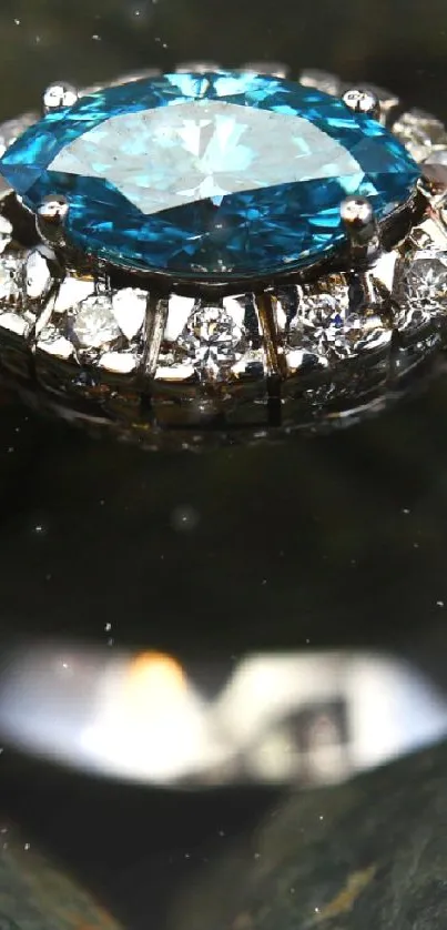 Close-up of a diamond ring with a blue gemstone on textured stones.