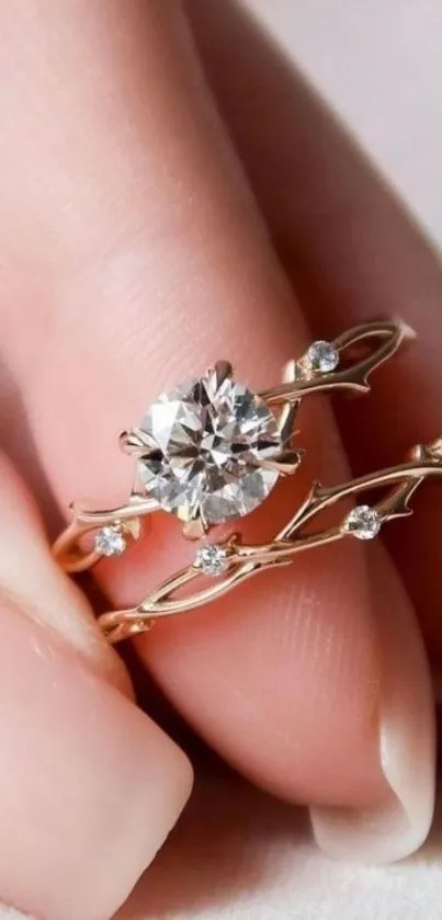 Elegant diamond ring with delicate gold details on a finger.