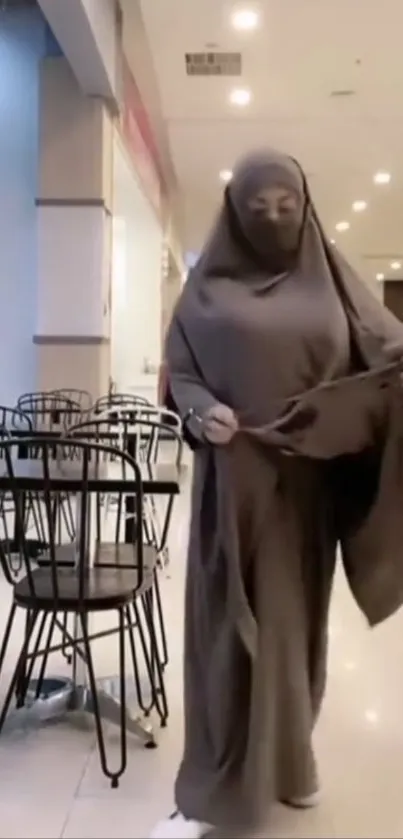 Person in brown attire at a dining area indoors.