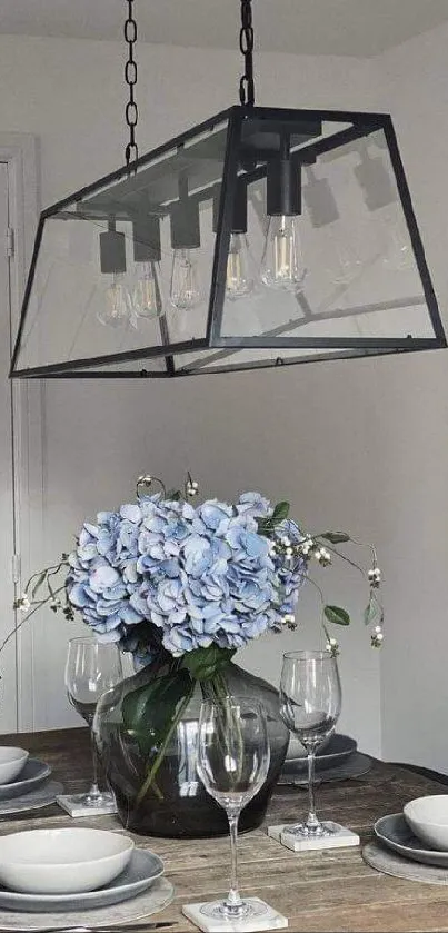 Dining room with chandelier and blue flowers centerpiece.