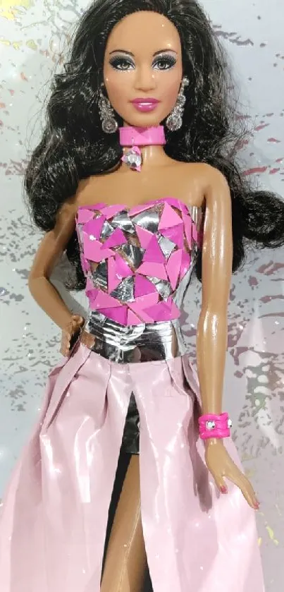 Elegant doll in pink and silver attire with dark hair against a textured backdrop.