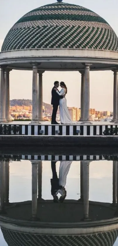 Romantic couple under dome reflected in water.