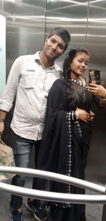 Couple in elegant attire in elevator mirror.