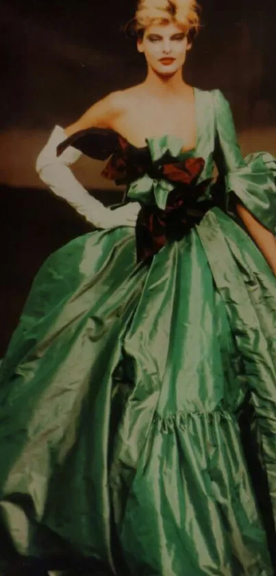 Model in an elegant emerald ballroom gown, striking a glamorous pose.