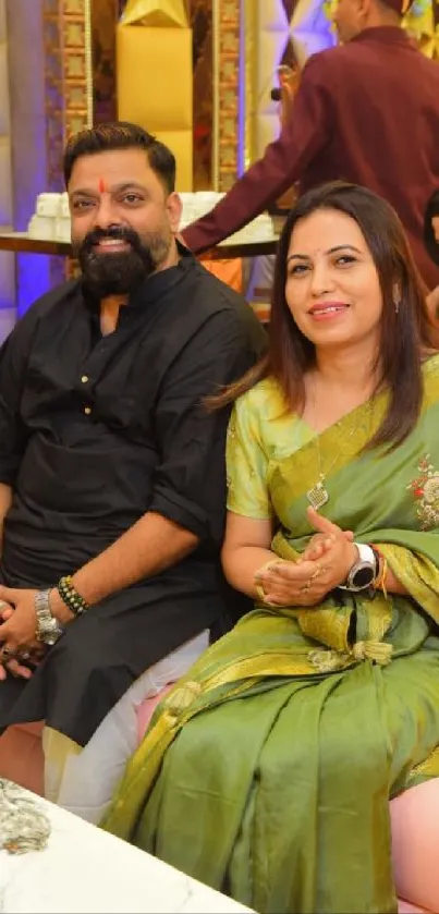 Portrait of two people sitting at a vibrant evening gathering.