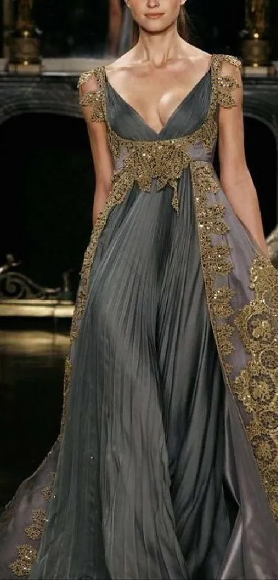 Elegant woman in a gray evening gown with gold embellishments.