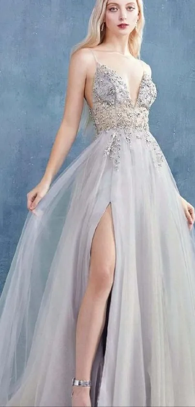 Elegant evening gown on model with blue-gray background.