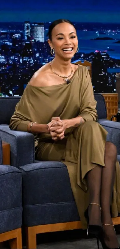 Elegant guest seated on a talk show set.