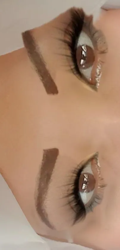 Close-up of expressive eyes with styled brows and long lashes.