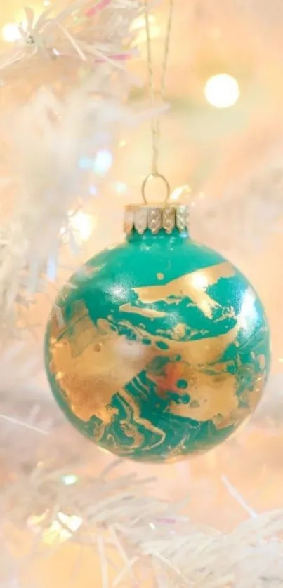 Teal and gold ornament on white branch wallpaper.