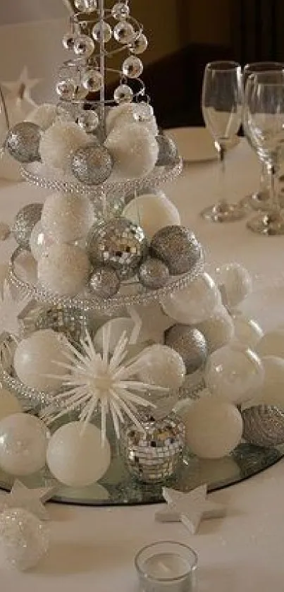 Elegant white and silver festive table centerpiece with glassware.