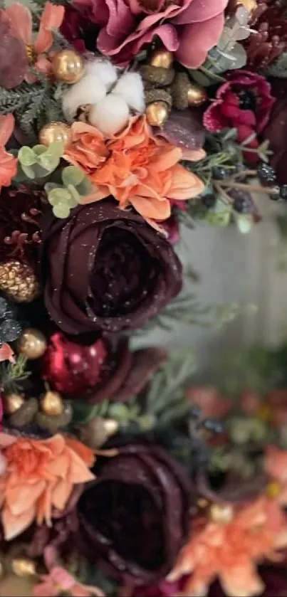 Burgundy and orange floral wreath with greenery.