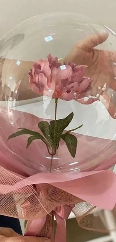 Elegant pink flower inside a glass balloon.