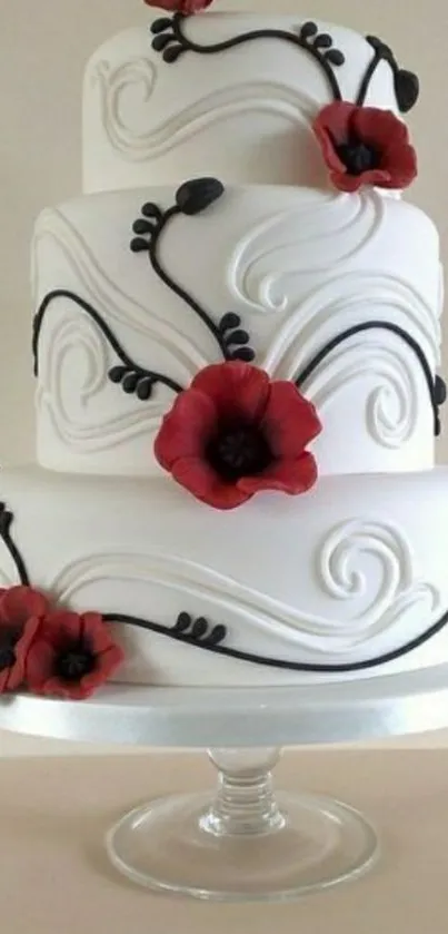 Three-tier elegant cake with red floral accents and artistic swirls.