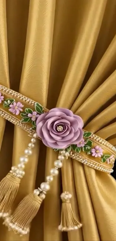 Gold curtain with floral embellishment and tassels.