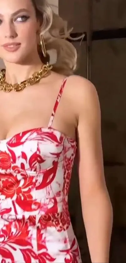 Woman in a floral red and white dress with gold accessories.