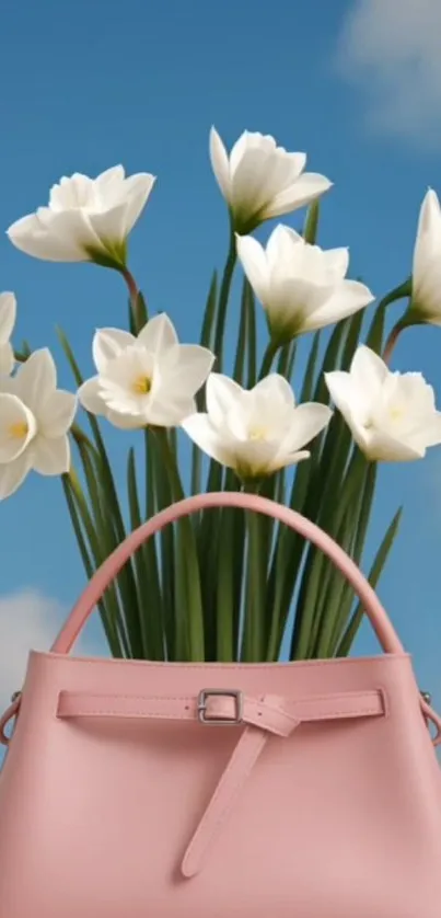 Pink handbag with white flowers against blue sky.