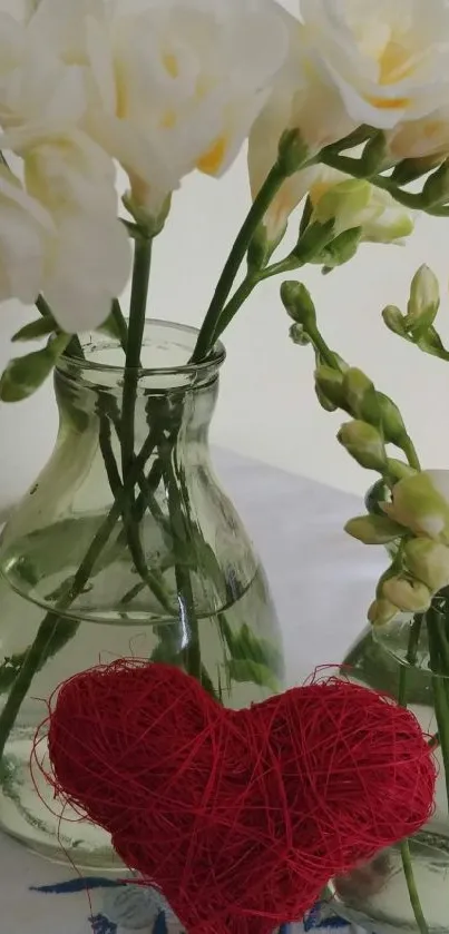 White flowers in vases with a red heart.