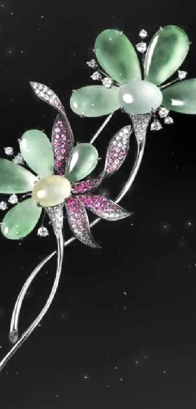 Elegant floral jewel design with green and pink gemstones on black background.