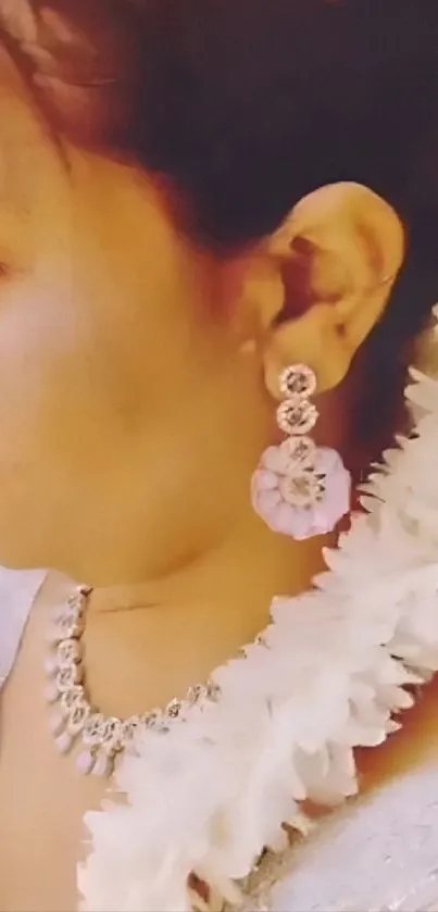 Close-up of a woman wearing floral jewelry and an elegant outfit.