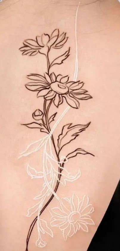 Floral line art tattoo design on back skin.