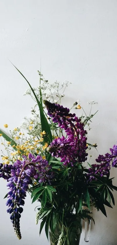 Purple and yellow floral arrangement on a white background.