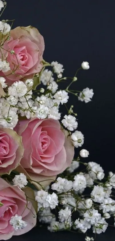 Elegant bouquet of pink roses and white flowers on dark background.