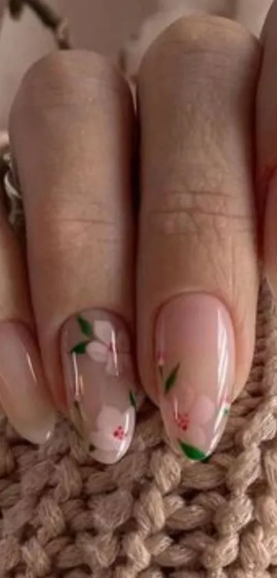 Floral nail art design on beige textured background.