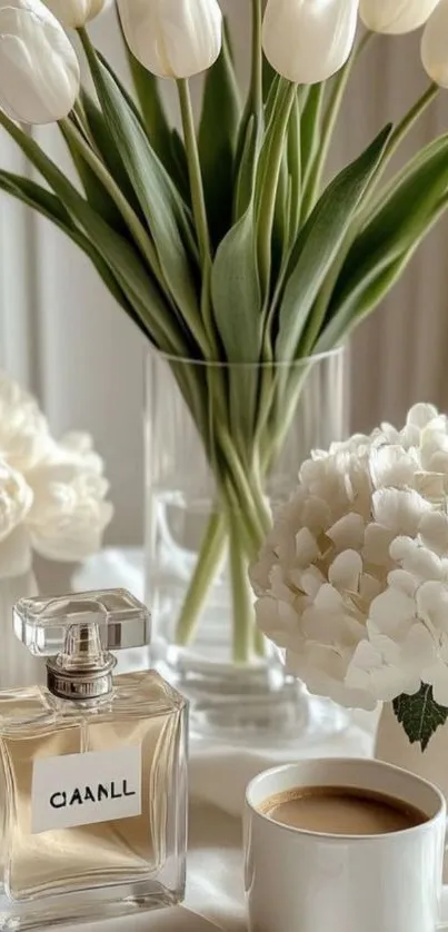 Elegant floral display with perfume and coffee on table.