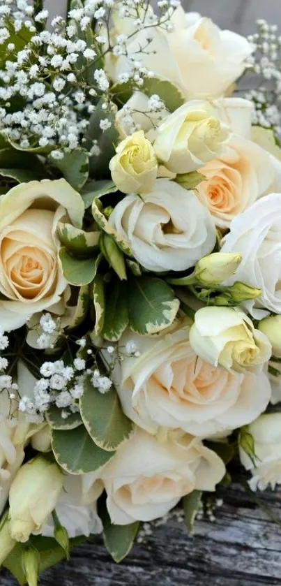 A bouquet of cream and white roses on a textured surface.